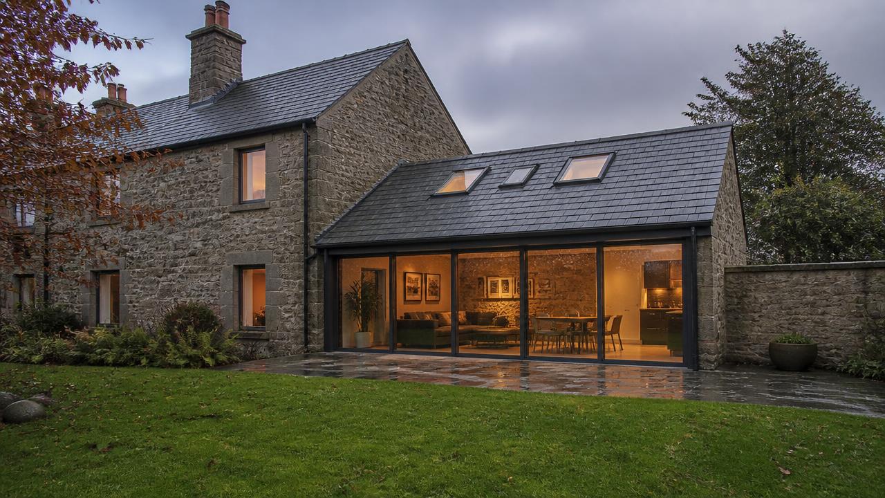 Modern glazed rear extension of a home with garden view